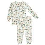 The Magnetic Me Baby Boys' and Boys' Dumps Like A Truck Modal PJ Set features a white background with colorful vehicles print and includes long-sleeve top and matching pants, made from soft modal for all-night comfort.