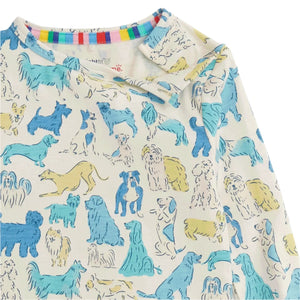 A close-up of the Boys' It's A Paw-ty Blue PJ Set by Magnetic Me, showcasing a kids' shirt with a playful dog-print pattern in blue, yellow, and beige tones.