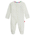 The Magnetic Me Baby Girl's Eloise Organic Cotton Magnetic Footie features long sleeves, a white base with green floral prints, a colorful striped neckline trim, and easy magnetic closures.