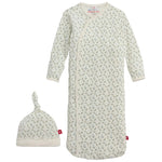 The Baby Girls' Eloise Organic Cotton Magnetic Gown & Hat Set by Magnetic Me includes a white long-sleeve sleep sack with zip closure and a matching knotted hat, both decorated with a small grey-green leaf pattern.