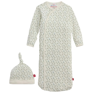 The Baby Girls' Eloise Organic Cotton Magnetic Gown & Hat Set by Magnetic Me includes a white long-sleeve sleep sack with zip closure and a matching knotted hat, both decorated with a small grey-green leaf pattern.