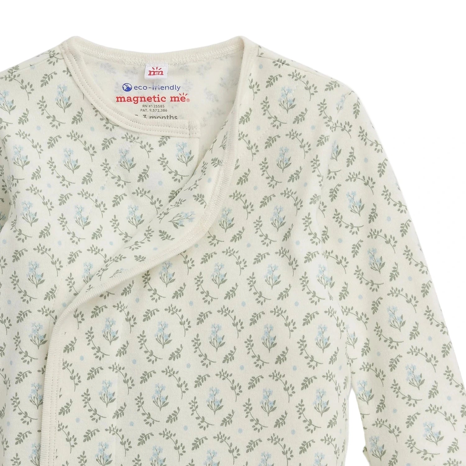 A close-up of the Baby Girls' Eloise Organic Cotton Magnetic Gown & Hat Set by Magnetic Me, featuring a light floral print, magnetic snap closure, and eco-friendly GOTS-certified fabric.