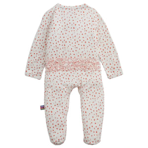 Introducing the Magnetic Me Baby Girls' Apple Blossom Modal Ruffle Footie—a cozy white baby onesie crafted from soft modal, featuring long sleeves, an adorable pink apple blossom print, and charming ruffle detail across the back. Designed for comfort, it also includes a small striped tag on the left side.