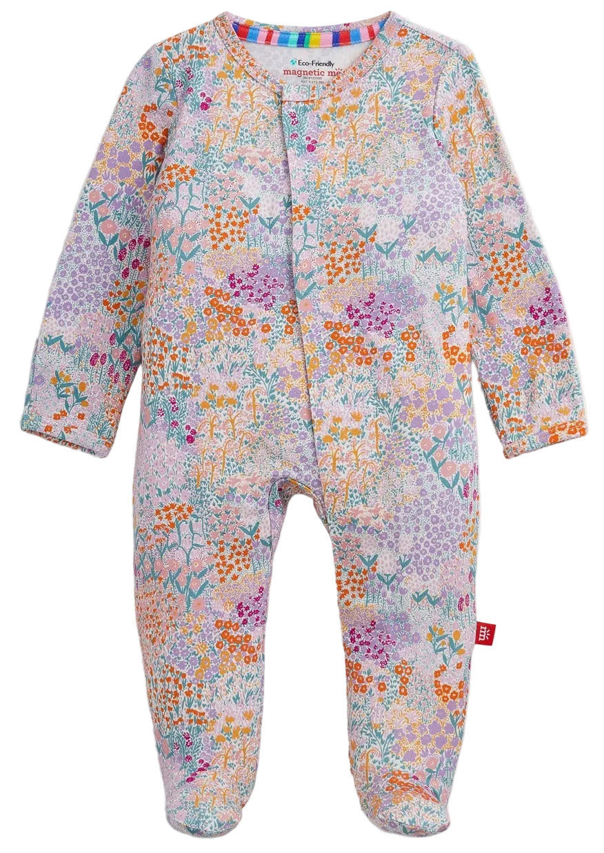 The Baby Girls’ Arabella Modal Footie by Magnetic Me features long sleeves, a vibrant floral and geometric print, and magnetic closures, shown flat on a white background.
