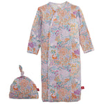 The Baby Girls’ Arabella Gown + Hat Set by Magnetic Me, with a vibrant floral print and matching knotted hat, is ideal newborn sleepwear.