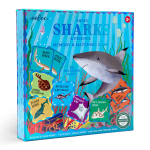 The Eeboo Sharks & Friends Shiny Memory Matching Game comes in a colorful box with illustrated sharks and fish, includes 24 matching pairs, and is a fun educational activity to boost memory skills for ages 3+.
