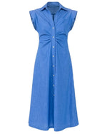 The Miami Dress by Callas Milano is a sleeveless blue midi shirt dress featuring a button-down front, shirt collar, and gathered waist detail for a flattering fit-and-flare silhouette.