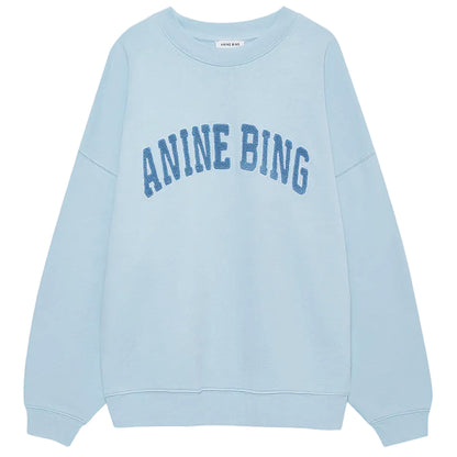 The Anine Bing Miles Sweatshirt is a pale blue, oversized crewneck pullover featuring bold "ANINE BING" lettering across the chest for a relaxed, stylish fit.