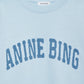 The Miles Sweatshirt by Anine Bing is an oversized pale blue cotton fleece crewneck featuring large textured "ANINE BING" lettering on the chest and a white neck tag with the brand name.