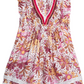 The Poupette St Barth Girls' Sasha Mini Dress is an adorable outfit featuring a multi-colored floral print with ruffled sleeves and a V-neck design, embellished with colorful fringes in charming pink and orange patterns.