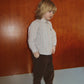 A young child wears a striped button-down shirt and relaxed-fit Baby Boys’ and Boys’ Remy Pants by Konges Slojd.