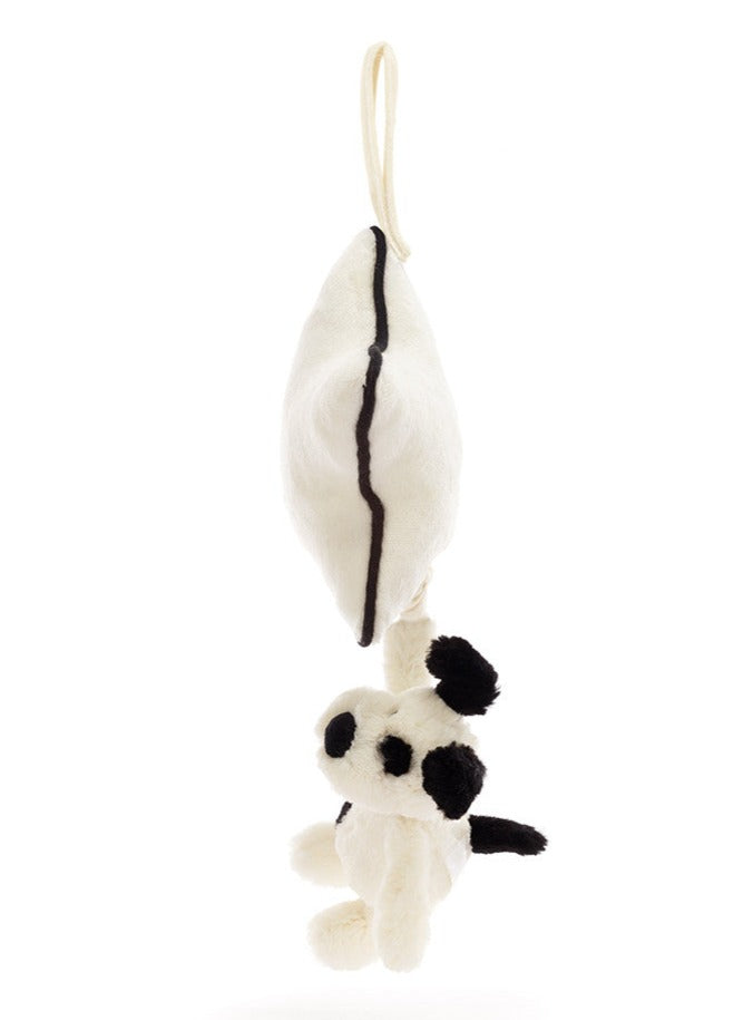 A white plush toy resembling a panda hangs by an ivory loop attached to a matching plush object with a single black stripe, perfect for a newborn. The soft cream fur is reminiscent of the Jellycat Bashful Black & Cream Puppy Musical Pull, adding an extra touch of cuddliness.