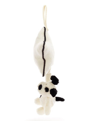 A white plush toy resembling a panda hangs by an ivory loop attached to a matching plush object with a single black stripe, perfect for a newborn. The soft cream fur is reminiscent of the Jellycat Bashful Black & Cream Puppy Musical Pull, adding an extra touch of cuddliness.