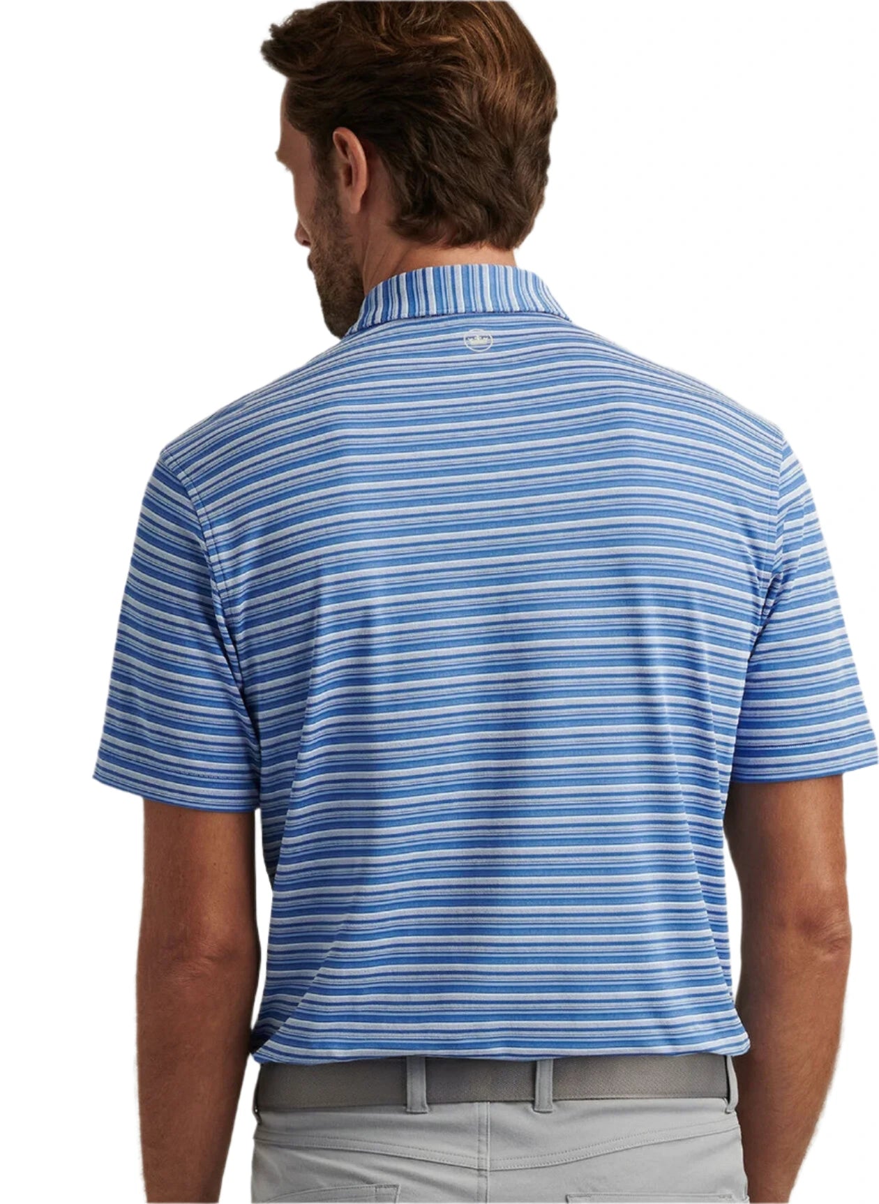 A man is shown from the back wearing a blue and white striped Peter Millar Atrium Performance Jersey Polo with Summer Comfort, paired with light gray pants.