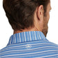 A man is seen from behind wearing the Peter Millar Atrium Performance Jersey Polo, designed with Summer Comfort fabric in blue and white stripes and finished with a small white logo on the upper back.