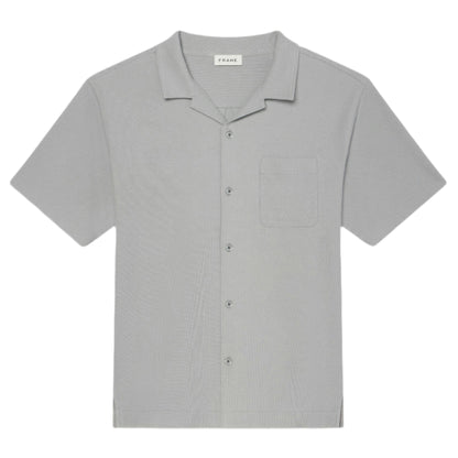 The Frame Jacquard Short Sleeve Relaxed Shirt in light gray features textured cotton, a notched collar, single chest pocket, and is displayed flat on a white background.