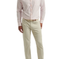 Man wearing a Peter Millar Hanford Performance Twill Sport Shirt in light pink, beige pants, and tan shoes.