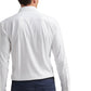 A traveler wearing the Excursionist Flex Solid Sport Shirt by Peter Millar, a white cotton-stretch long-sleeve shirt, is seen from behind, paired with dark pants.