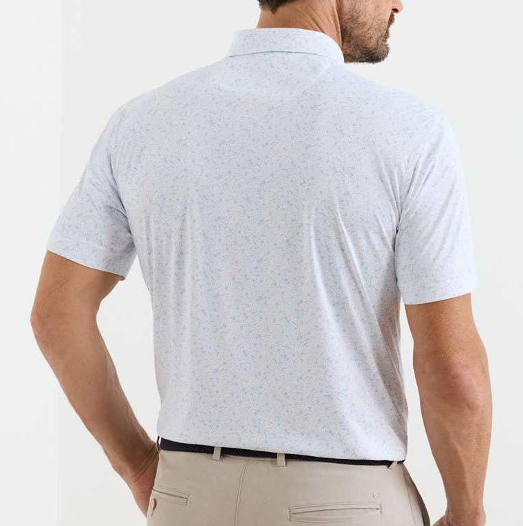 A man is seen from the back wearing a Peter Millar Featherweight Land Of The Free Performance Polo, which features short sleeves, a light color, UPF 50+ sun protection, and beige pants.