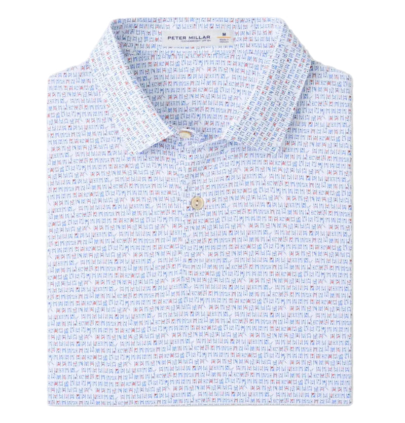 A folded “Featherweight Cornhole Performance Polo” by Peter Millar features a collared, two-button design with subtle multicolored geometric print, four-way stretch, and UPF 50+ sun protection.