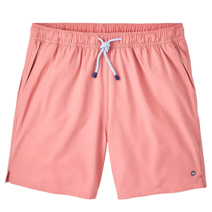 The Peter Millar Crown Swim Trunk features light pink fabric, a light blue drawstring on an elastic waistband, side pockets, and a mesh liner for comfort. Displayed against a white background.
