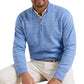 A man wears the Peter Millar Saratoga Striped Quarter-Zip Sweater over a collared shirt and white pants, seated with his upper body visible against a white background.