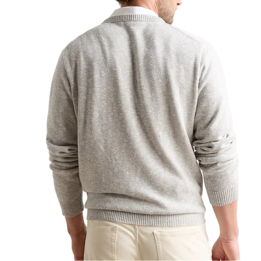 A man is seen from behind wearing a light gray Peter Millar Montauk Crewneck Sweater and light-colored pants against a white background.