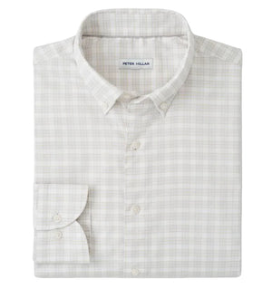 The Peter Millar Douglas Crown Lite Cotton-Stretch Sport Shirt is a light plaid, long-sleeve twill button-up, neatly folded with the "Peter Millar" label visible, crafted from easy-care stretch cotton for comfort and style.