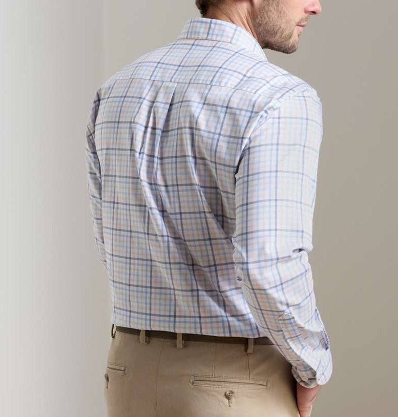 A man is shown from the back wearing a Peter Millar Warren Crown Lite Cotton-Stretch Sport Shirt in light blue and tan plaid, tucked into tan pants.
