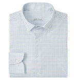 The Rommel Performance Twill Sport Shirt by Peter Millar features a light blue and white check, UPF 50+ performance fabric, and a visible "Peter Millar" label on the inside collar.