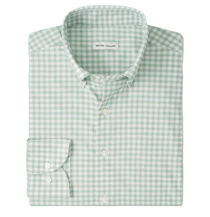 The folded Lewis Performance Twill Sport Shirt by Peter Millar is green and white checkered, features a collar and single cuff, and is crafted from performance fabric with UPF 50+ protection.