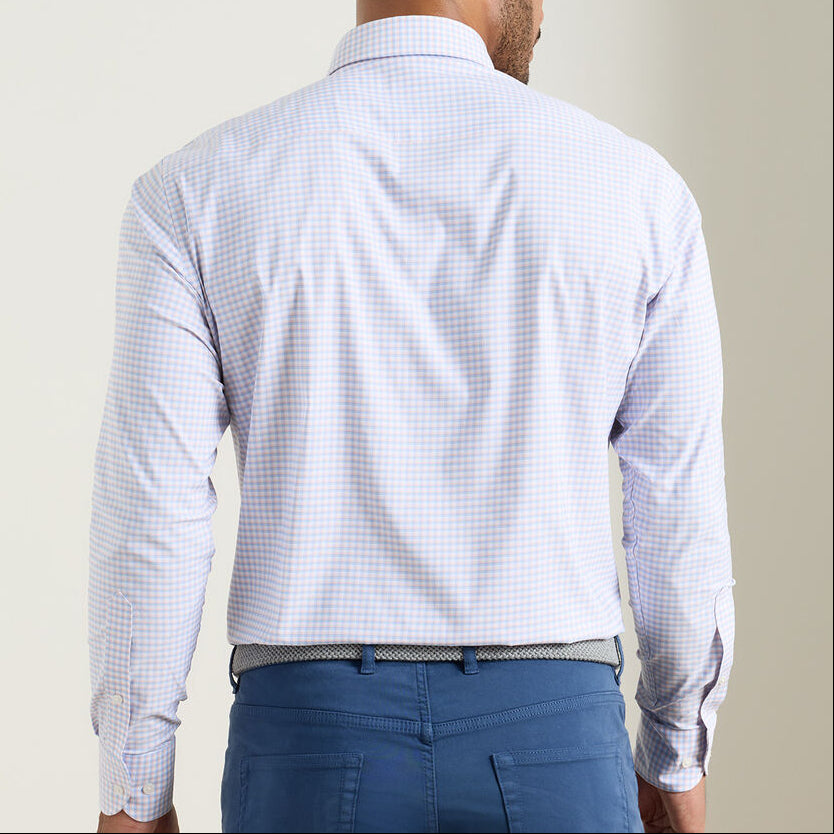 A man is shown from the back wearing a Peter Millar Gregory Performance Twill Sport Shirt in light blue check, paired with blue pants and a white and blue braided belt.