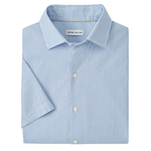 The Peter Millar Coastal Stripe Sport Shirt is a light blue and white seersucker, short-sleeve button-up, shown neatly folded with the brand label visible inside the collar.