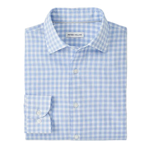 The Breeze Cotton Lyocell Sport Shirt by Peter Millar is a featherweight long-sleeve shirt in a light blue and white check pattern, expertly folded with the "Peter Millar" label visible inside the collar.