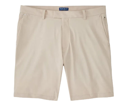The Bingham Performance Short by Peter Millar in beige is a wrinkle-resistant, knee-length style featuring belt loops, front pockets, and a zipper fly, shown laid flat on a white background.