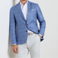 Man wearing the Peter Millar Reynolds Plaid Soft Jacket—a light blue checkered blazer—paired with a white shirt, light gray pants, and a belt. A versatile wardrobe essential showcasing European craftsmanship.