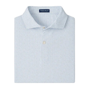 The Alder Performance Jersey Polo by Peter Millar is a light blue, collared shirt with two buttons, an interior "Peter Millar" label, and UPF 50+ sun protection, neatly folded for display.
