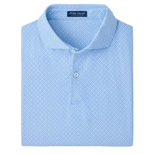 The Peter Millar Granada Performance Jersey Polo in blue, featuring four-way stretch and UPF 50+ sun protection, is neatly folded on a white background.
