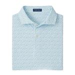 The Peter Millar Wood Fired Performance Jersey Polo is a light blue patterned shirt featuring a button-down collar, four-way stretch for comfort, and the Peter Millar label inside the neckline.