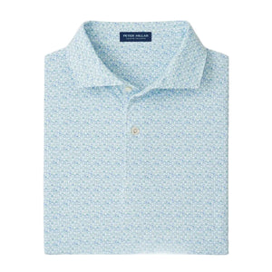The Peter Millar Wood Fired Performance Jersey Polo is a light blue patterned shirt featuring a button-down collar, four-way stretch for comfort, and the Peter Millar label inside the neckline.