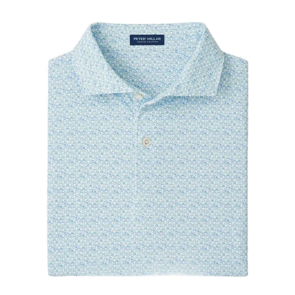 The Peter Millar Wood Fired Performance Jersey Polo is a light blue patterned shirt featuring a button-down collar, four-way stretch for comfort, and the Peter Millar label inside the neckline.
