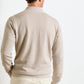 A man is shown from the back against a white background, wearing cream pants and the Peter Millar Barlow Quarter-Zip Sweater, crafted from a Merino-linen-cotton blend.