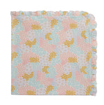 The Harper Ruffle Blanket by Magnetic Me is a folded quilt featuring a pastel floral pattern in yellow, pink, and light blue with a ruffled edge along two sides—perfect as a cozy stroller blanket for little ones on the go.