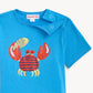 Boys’ Deep Chic Magnetic Top from Magnetic Me features a blue color with a playful red crab and yellow fish graphic on the front, crafted from soft TENCEL™ modal for extra comfort. It includes two snap buttons on the shoulder for easy dressing.