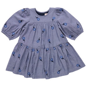 The Girls' Fiona Dress by Pink Chicken features long sleeves, puffed shoulders, a gathered skirt, and a round neckline with beautiful Blue Blossom floral embroidery.