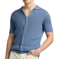 A person wearing the Onia Drop Needle Button Up in light blue, featuring a textured design and collar, paired with cream-colored pants.