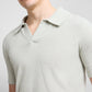 A person wears the Onia Boucle Knit Johnny Polo in light grey with short sleeves and a textured boucle knit, shown from shoulders to mid-torso.