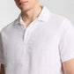 A person wearing the Onia Cotton Linen Pop-Over Polo, shown from shoulders to mid-torso, showcases its breathable comfort and relaxed silhouette.