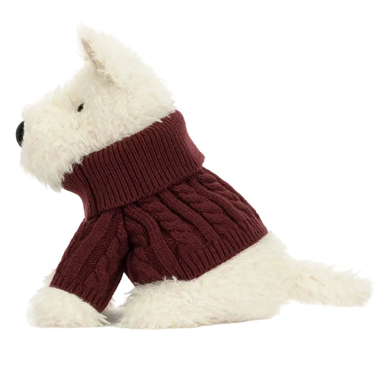 Jellycat Munro Scottie Dog Winter Jumper Outfit sits in profile, dressed in a maroon sweater, against a plain background.