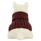 A white fluffy dog sits with its back to the camera, wearing a cozy maroon Munro Scottie Dog Winter Jumper Outfit by Jellycat with a wide turtleneck.